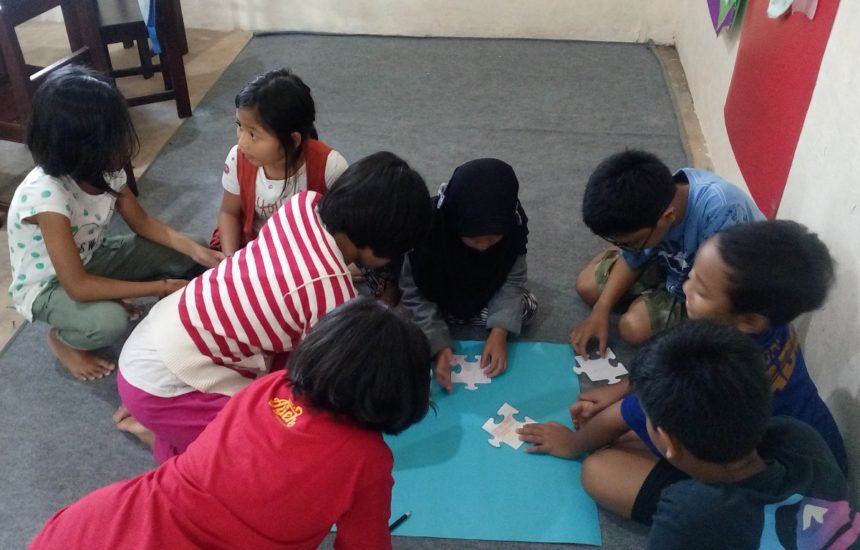 Children working on a puzzle together