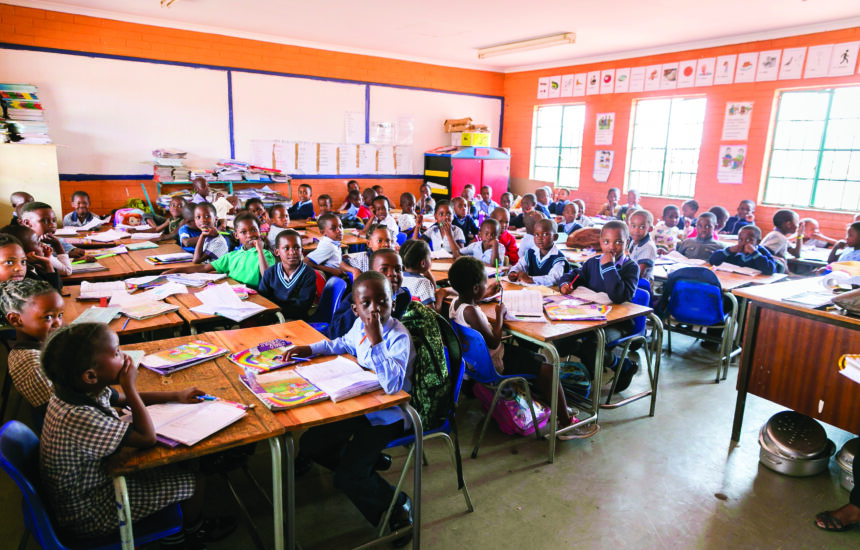 A classroom with students sitting at desks in South Africa.