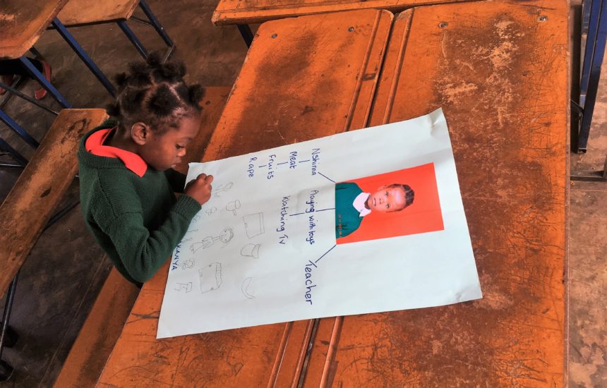 A young girl working on a school project