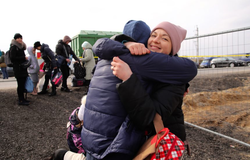Refugee mother and child embracing, demonstrating the theme of World Refugee Day.