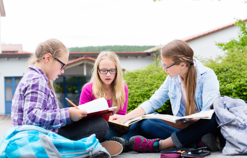 A group of kids doing schoolwork.