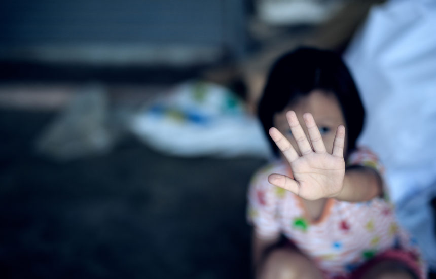 A girl puts her hand up