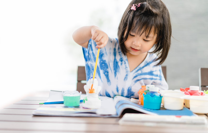 A young girl painting